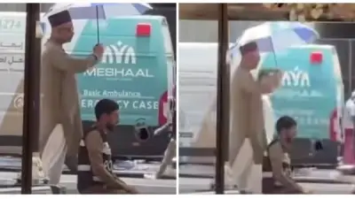 مشهد مؤثر.. حاج يظلل رجل أمن بمظلته أثناء الصلاة في الحر الشديد